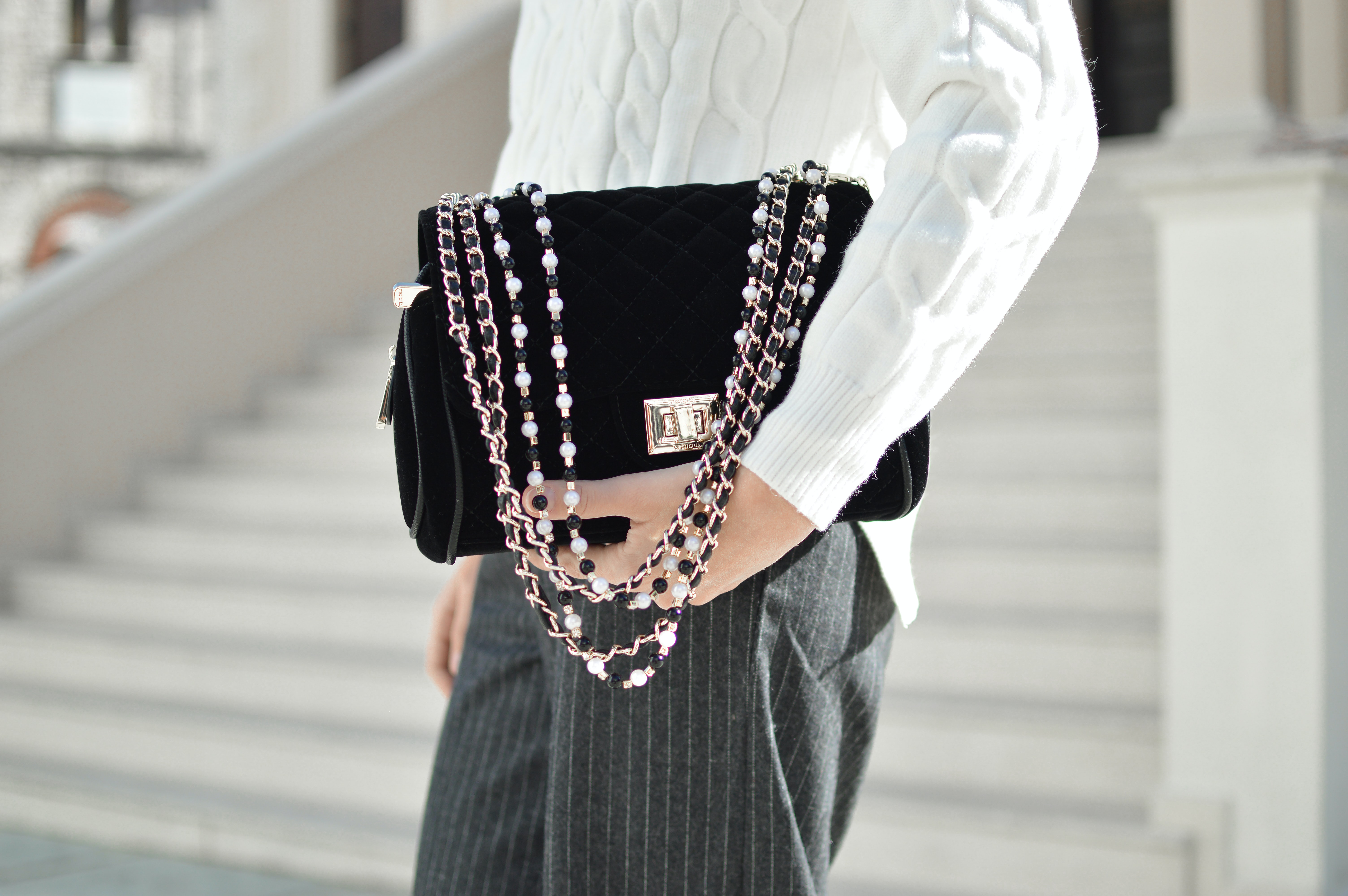 model carrying a black handbag